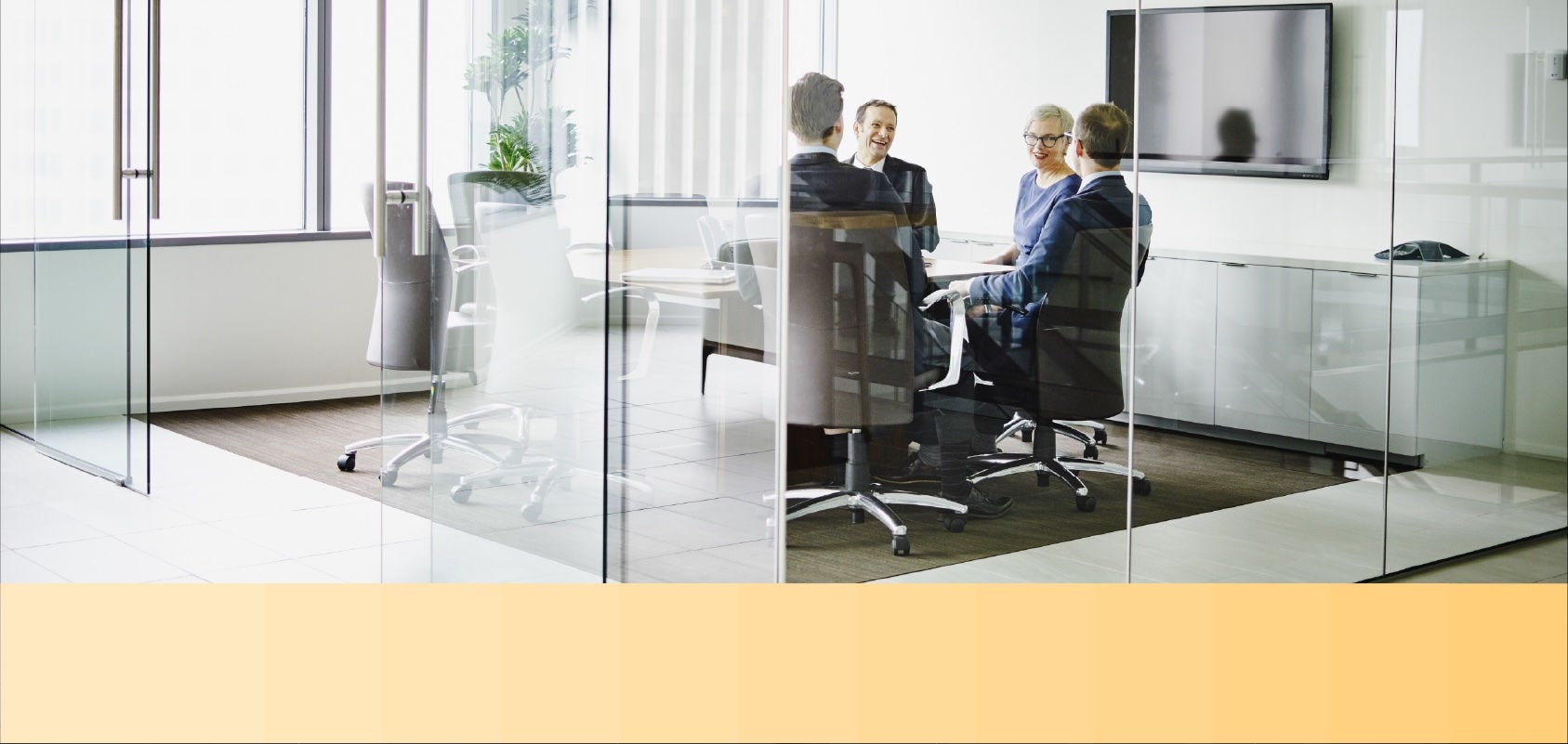 Professionals in business outfits hold a conference in a modern office room