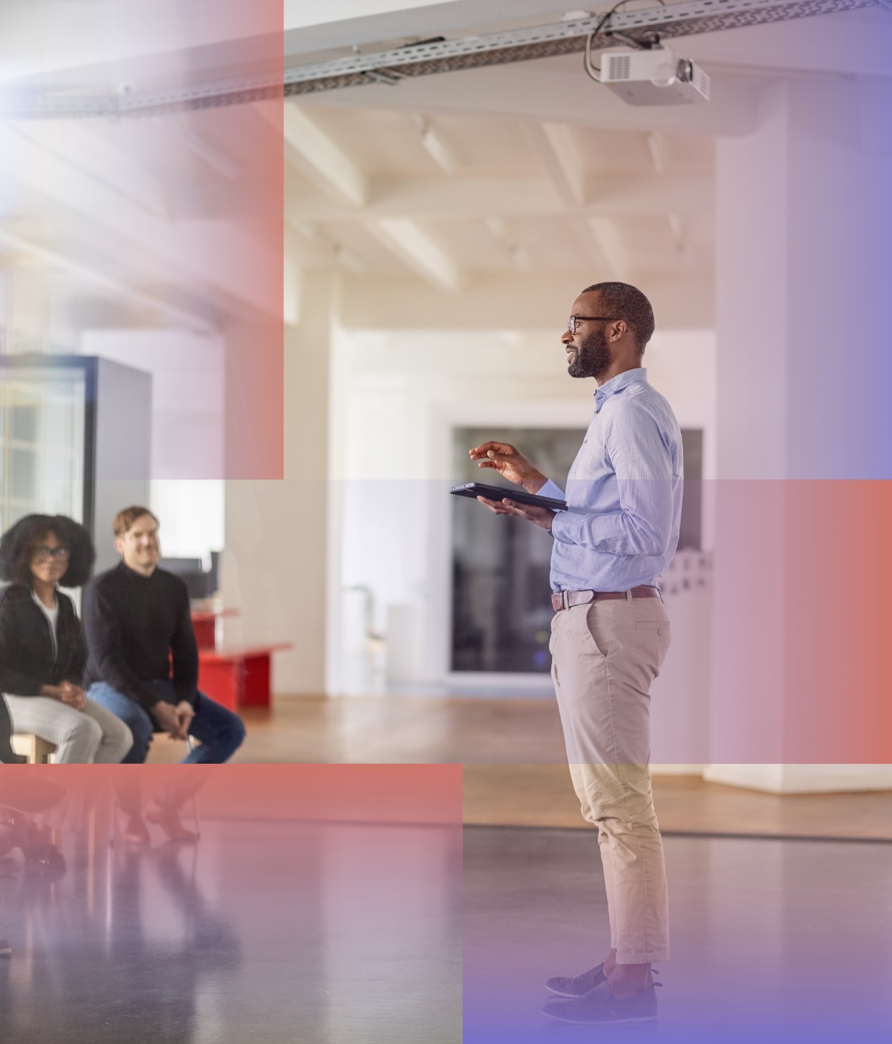Man giving a presentation to a crowd of office employees